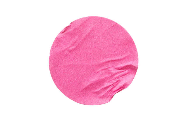 istock Blank pink round adhesive paper sticker label isolated on white background 1295540397