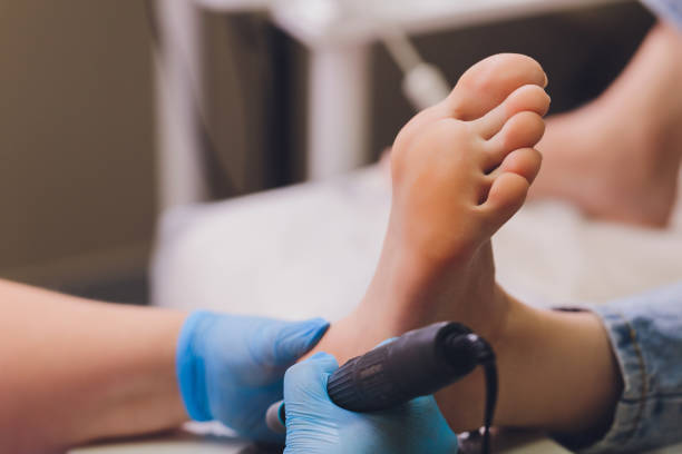 istock Process pedicure close-up, polishing feet, unrecognizable people. blurred face. 1295540551