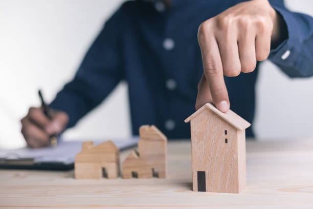 istock Close up Hand holding home with Buy or Rent. 1295546683