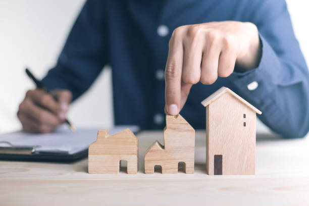 istock Close up Hand holding home with Buy or Rent. 1295546690