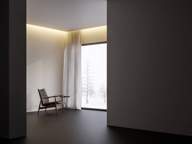 Minimal style living room with snow scence view 3d render,There are black tile floor,white wall.Finished with black leather chair,The room has large windows. Looking out to see the view of winter.
