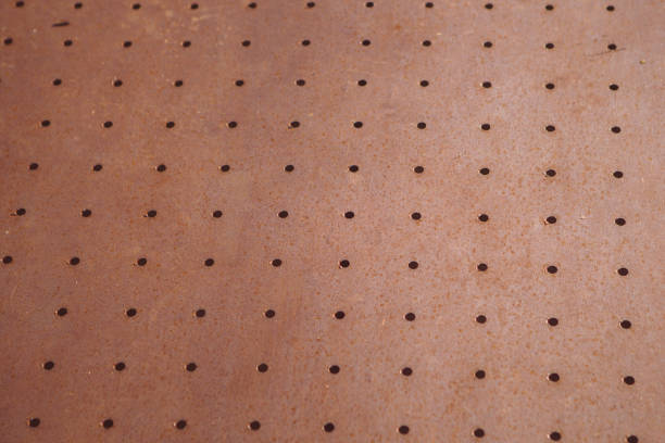 istock brown rusty metal plate with small holes placed in line 1295552278