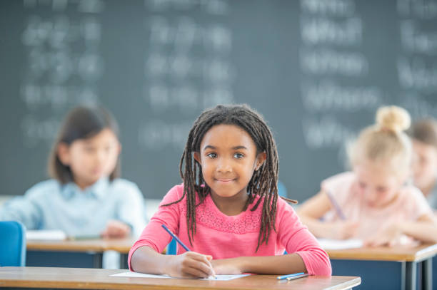 istock African girl in elementary classroom 1295555630