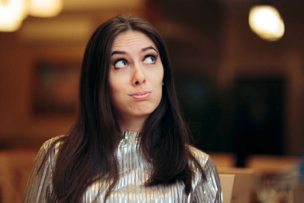 istock Bored Woman at a Party Thinking of Something Else 1295561079