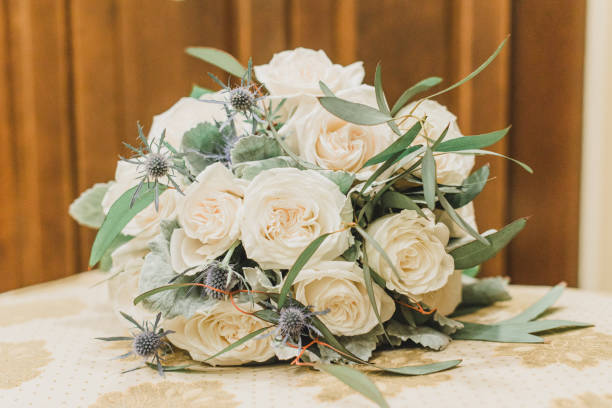 istock White roses bride's bouquet on textured surface 1295569195