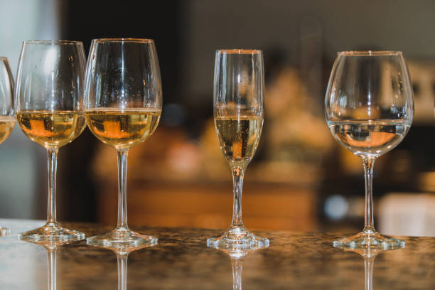istock 5 Champagne glasses lined up on a table warm bokeh background 1295571652