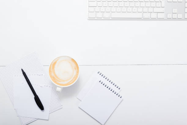 istock Office table with cup of coffee, top view 1295575881