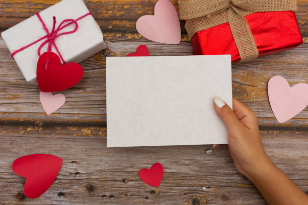 istock Female hand holding a blank card 1295575910