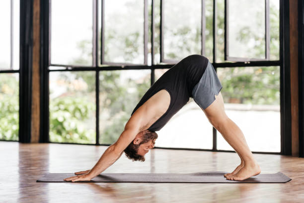 istock Yoga men workout in studio in front of a window 1295581328
