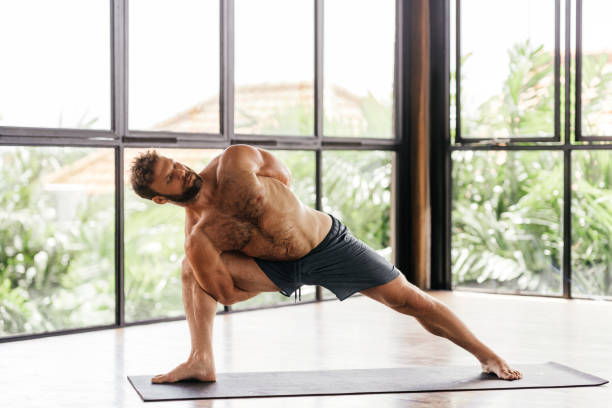 istock Yoga men workout in studio in front of a window 1295581330