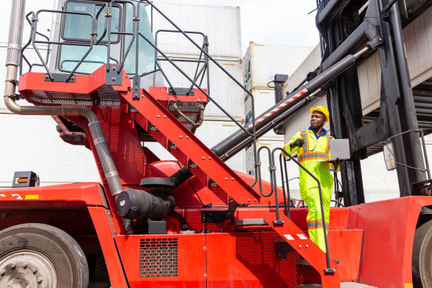 istock Foreman using laptop computer in the port of loading goods. Foreman showing thumbs up on Forklifts in the Industrial Container Cargo freight ship. 1295587568