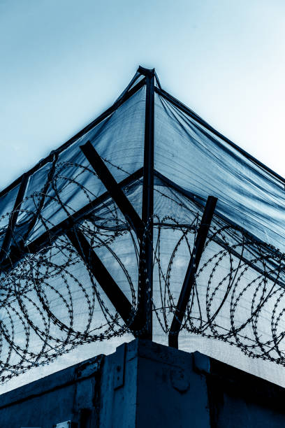 istock Close-up of barbed wire fence against 1295589977