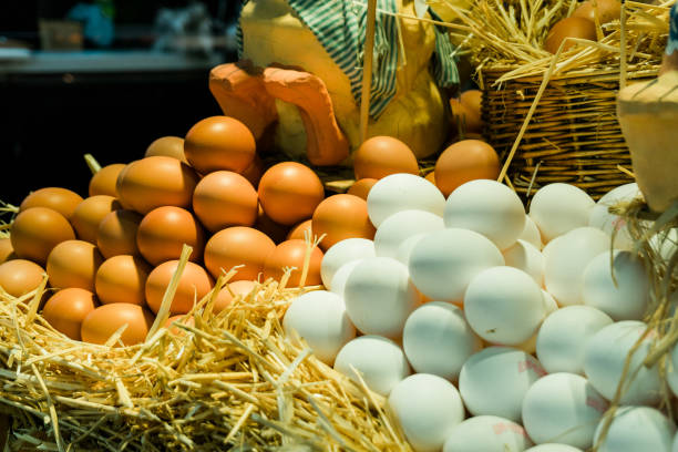Fresh white and brown eggs at the market