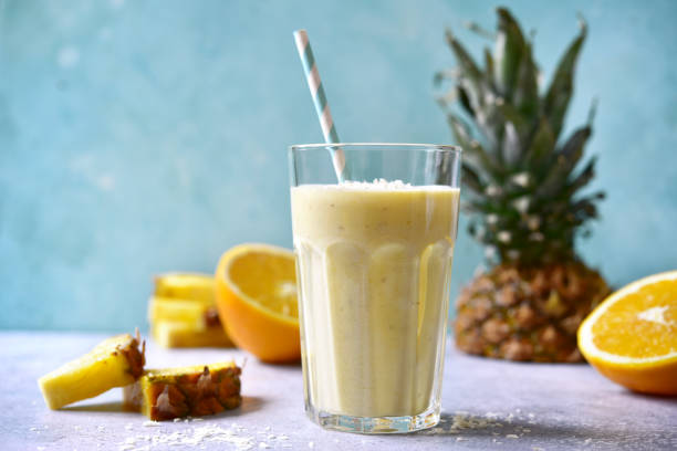 Tropical smoothie with pineapple, banana, coconut and orange