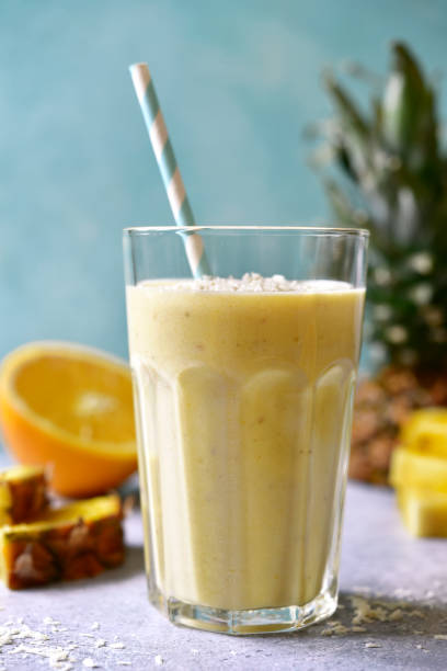 istock Tropical smoothie with pineapple, banana, coconut and orange 1295593127