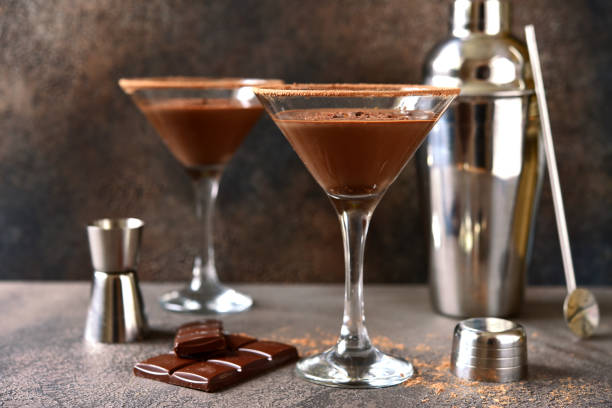 Delicious chocolate martini in a glasses Delicious chocolate martini in a glasses on a dark slate, stone or concrete background. martini stock pictures, royalty-free photos & images