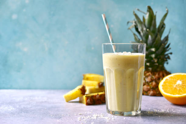 istock Tropical smoothie with pineapple, banana, coconut and orange 1295593173