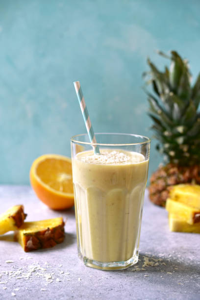 istock Tropical smoothie with pineapple, banana, coconut and orange 1295593174