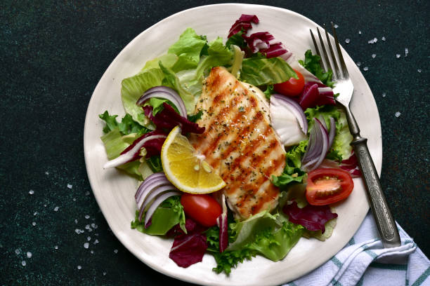 istock Grilled chicken breast with fresh vegetable salad 1295594018