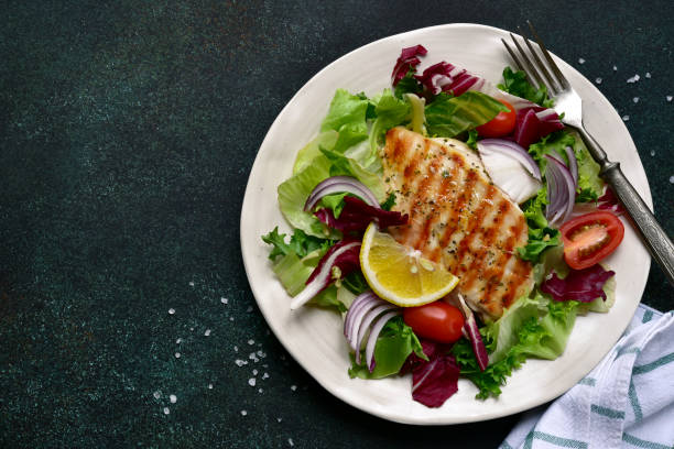 istock Grilled chicken breast with fresh vegetable salad 1295594052