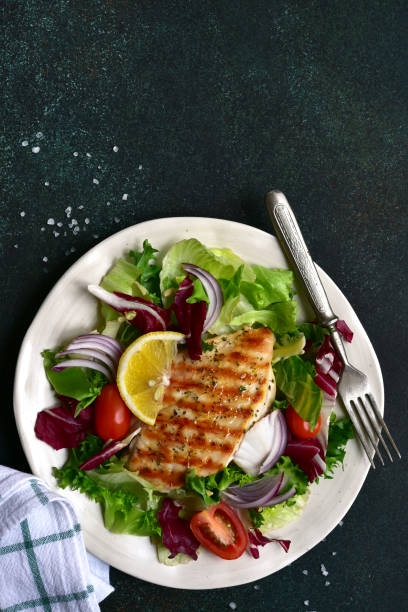 istock Grilled chicken breast with fresh vegetable salad 1295594071
