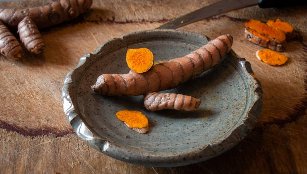 istock cut turmaric on a  blue plate on a chopping board. 1295595362