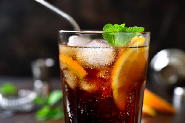 istock Cold summer soda cocktail with cola, dark rum and orange 1295595386