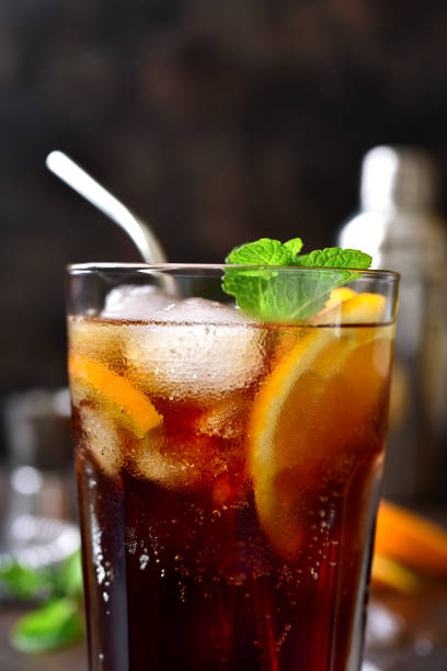 istock Cold summer soda cocktail with cola, dark rum and orange 1295595388