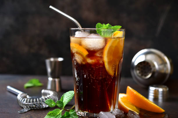 istock Cold summer soda cocktail with cola, dark rum and orange 1295595397