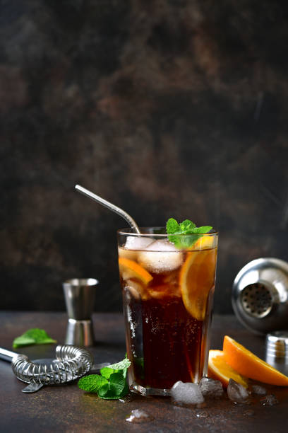 istock Cold summer soda cocktail with cola, dark rum and orange 1295595417