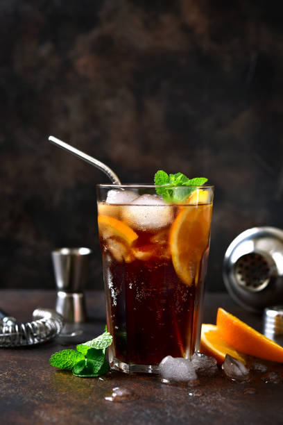 istock Cold summer soda cocktail with cola, dark rum and orange 1295595584