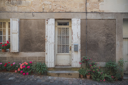 A charming rural doorstep scene in the village of Saint-Emilion in the wine region of Bordeaux, France