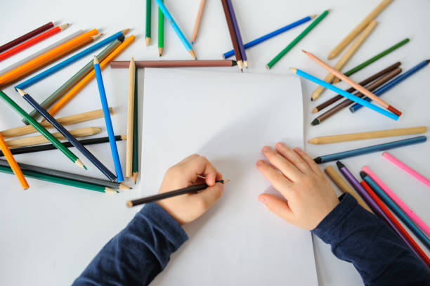 istock little boy paints greeting card with colour pencils 1295602958
