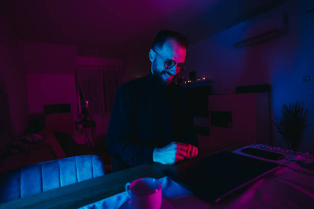 istock Man working on laptop at home office at night 1295603031