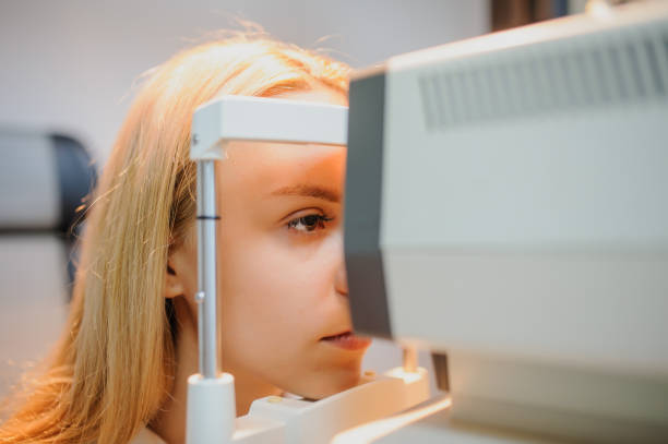 istock close up head of young patient fix in a non-mydriatic retinal camera 1295603066