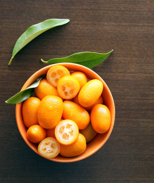 frutas kumquat con hojas, vista superior - kumquat fotografías e imágenes de stock