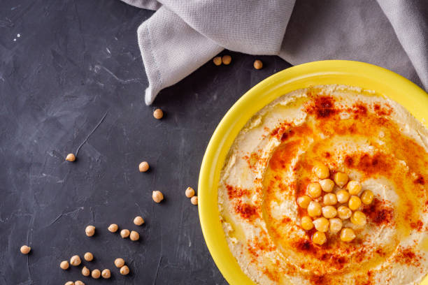 istock traditional turkish hummus on a dark stone background 1295610255