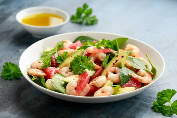 istock Fresh Avocado Grapefruit shrimp salad in white plate 1295610923