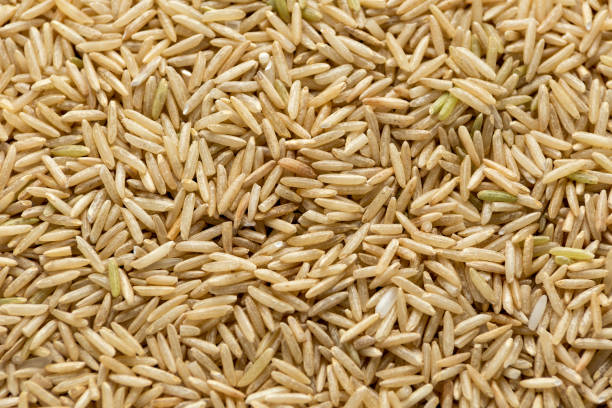 istock Close up uncooked Brown rice background texture 1295611627