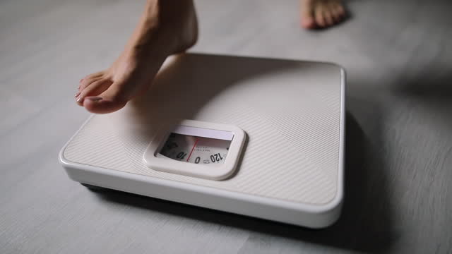Activity with leg of woman stand measuring weight scale for diet with barefoot