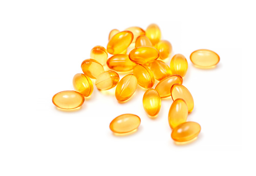 Fish oil capsules (medicine and health products) isolated on white