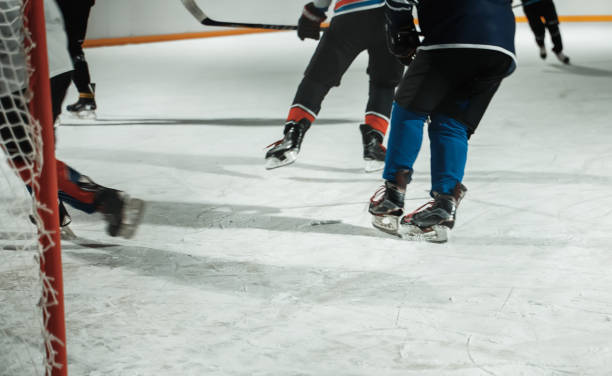 istock People play hockey outdoors in winter time. 1295615540
