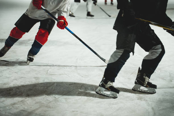 istock People play hockey outdoors in winter time. 1295615567