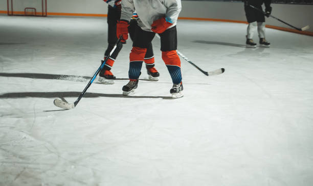 istock People play hockey outdoors in winter time. 1295615570