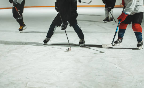istock People play hockey outdoors in winter time. 1295615571