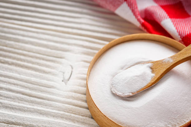istock baking soda powder on wooden rustic background background 1295617102