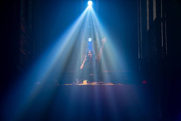 istock DJ on stage in disco night club mixing techno music beat 1295617231