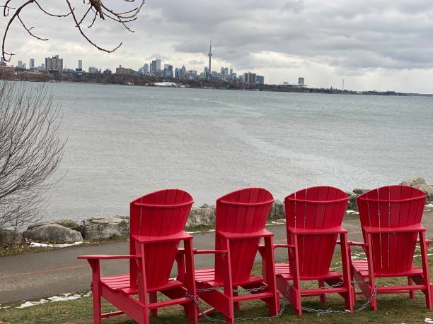 istock 4 red chairs and Toronto skyline across the lake 1295618082