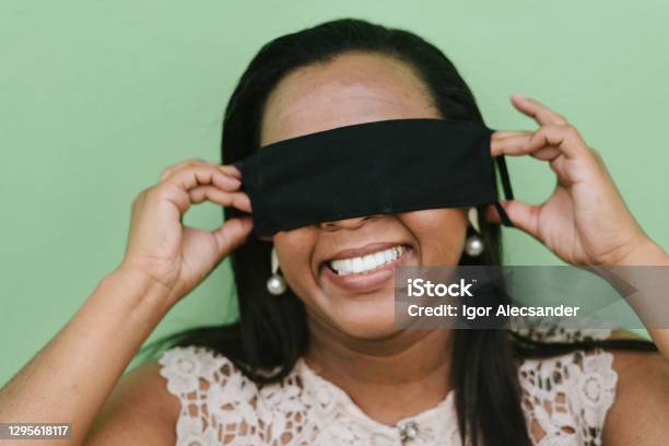 Woman Putting Protective Mask On Eyes Stock Photo - Download Image Now - Misinformation, One Woman Only, Fake News