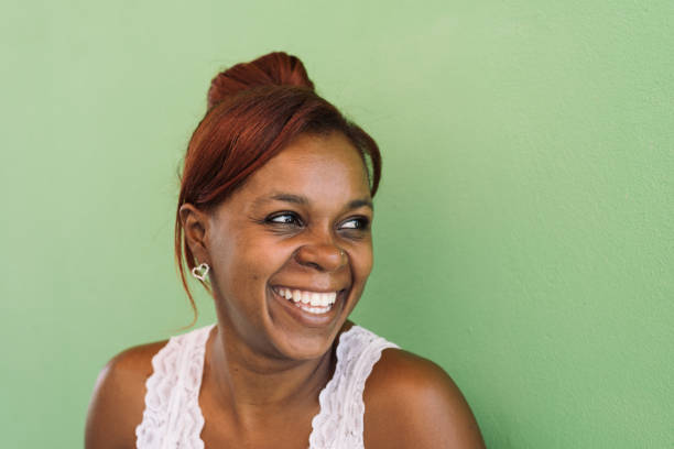 Smiling woman on green wall